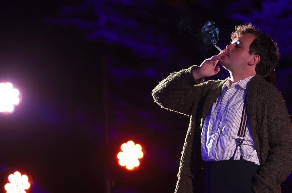 An actor smoking a cigarette