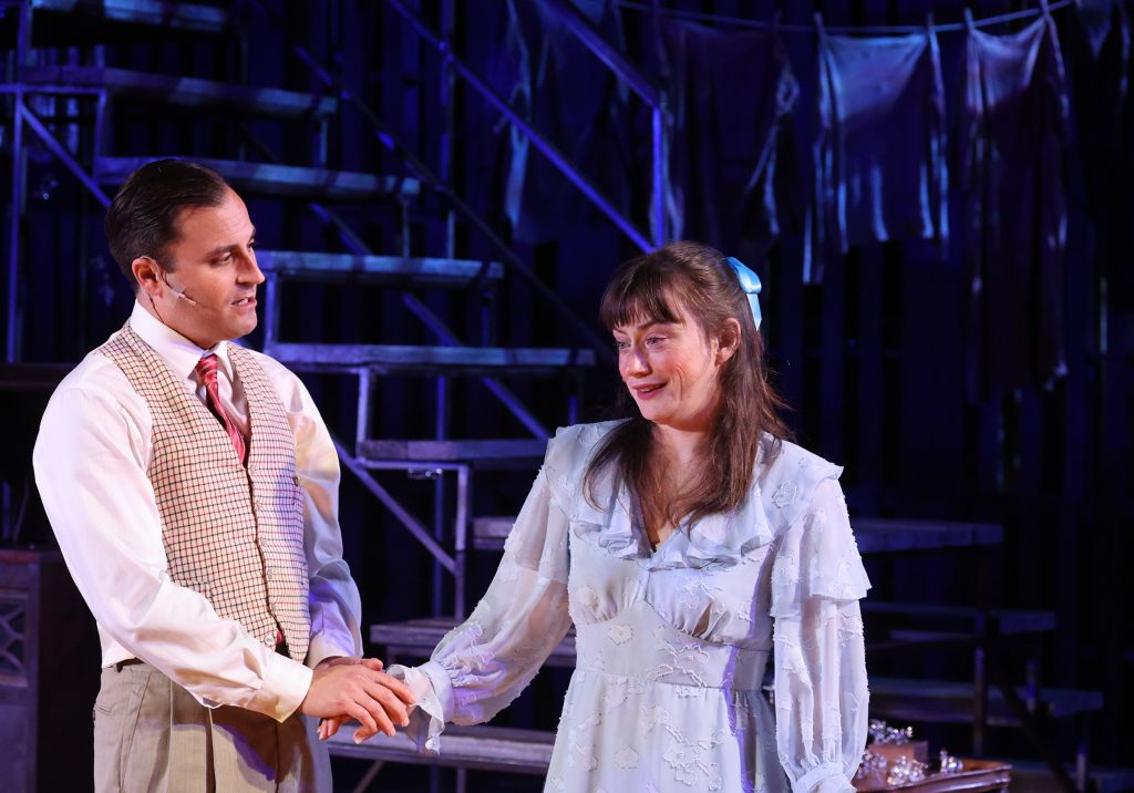 An actor and actress holding hands