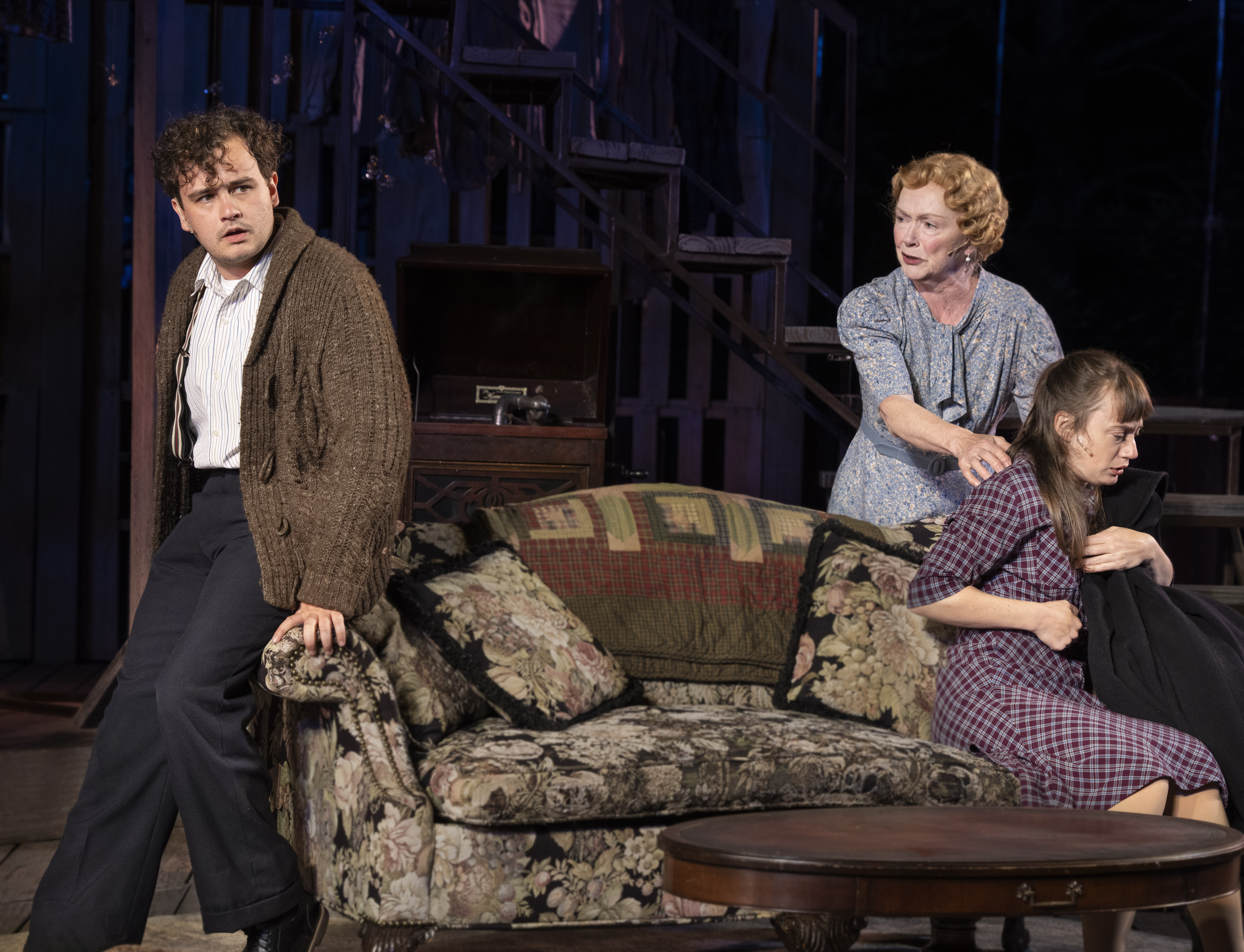 Three actors sitting on a couch