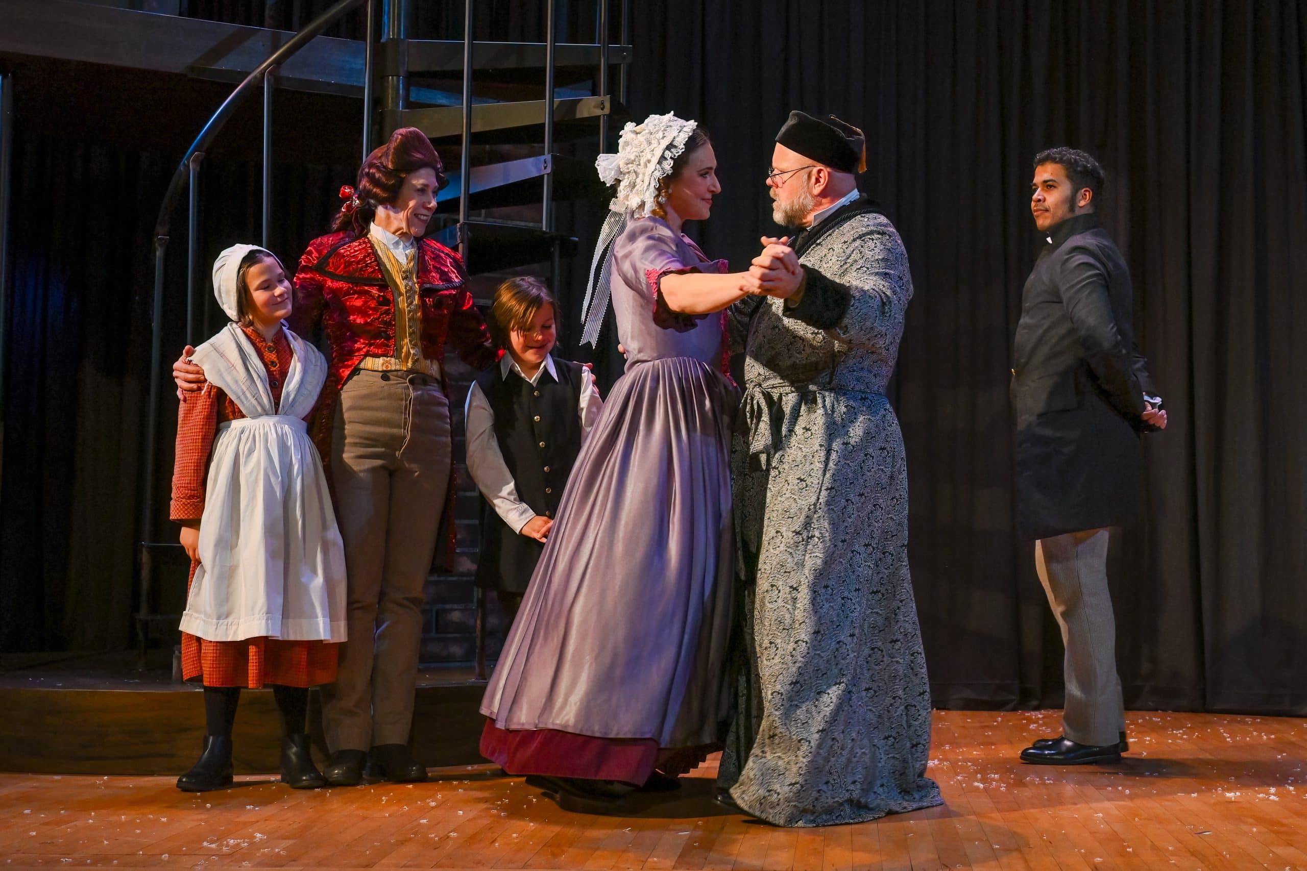 (Front) Charlotte Munson (Belle) and Mike Ryan (Scrooge) (Back, left to right) Aria Atkinson (Girl), Julie James (Fezziwig), Joseph Pratt Lukefahr (Boy) and Robert Zelaya (Young Scrooge)