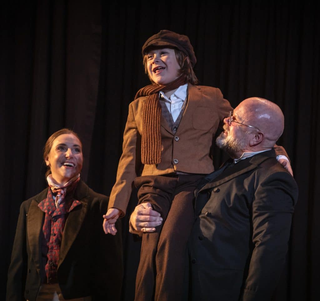 (Left) Charlotte Munson (Fred), Joseph Pratt Lukefahr (Tiny Tim) and Mike Ryan (Scrooge)