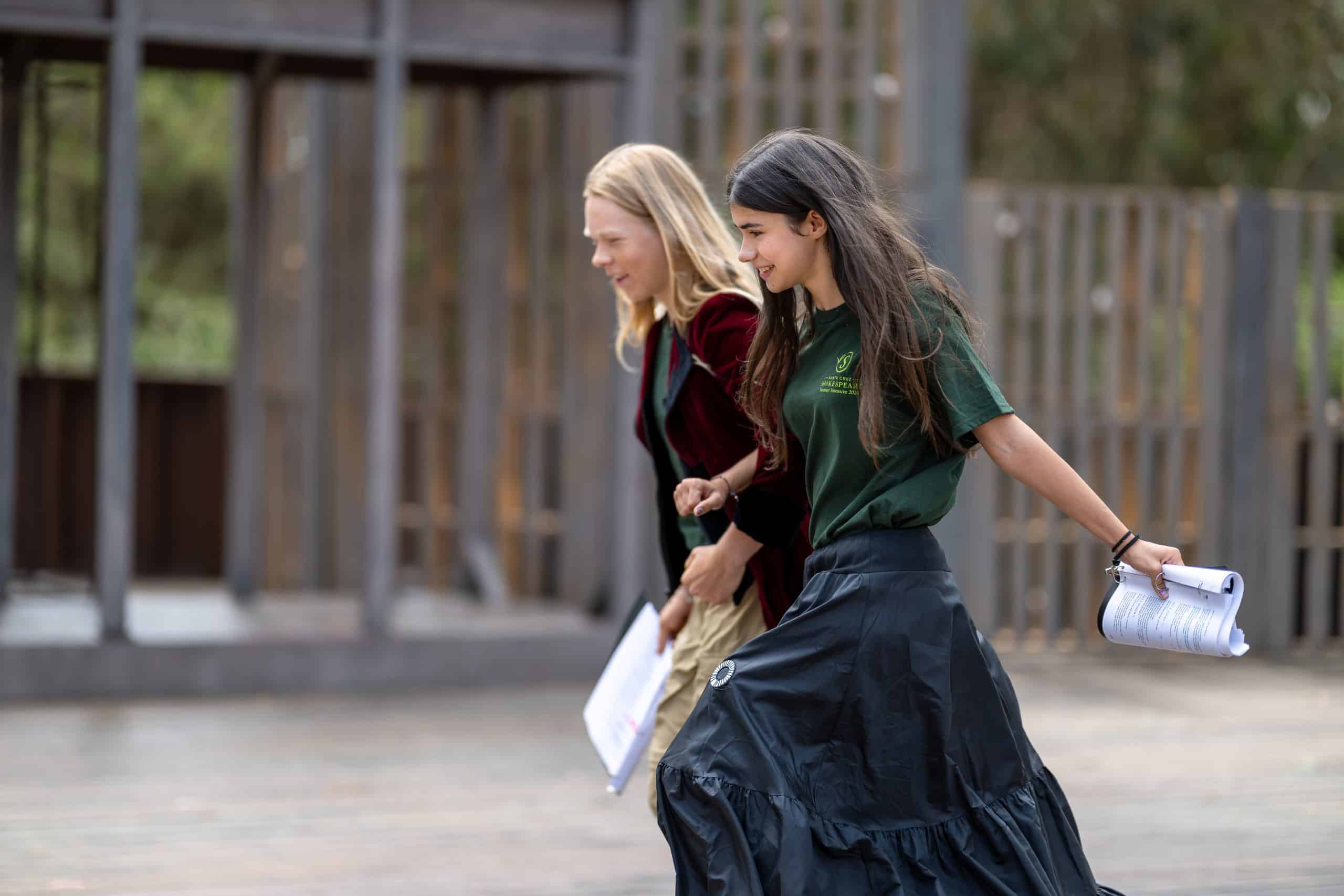 Two running kids holding scripts